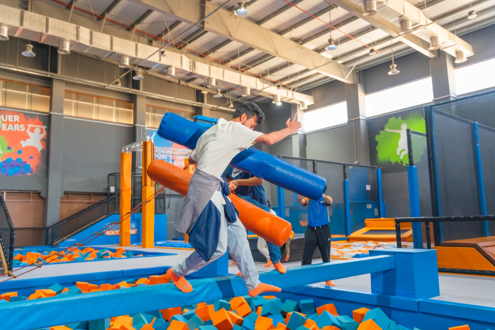 Kids playing on the Battle Beam attraction