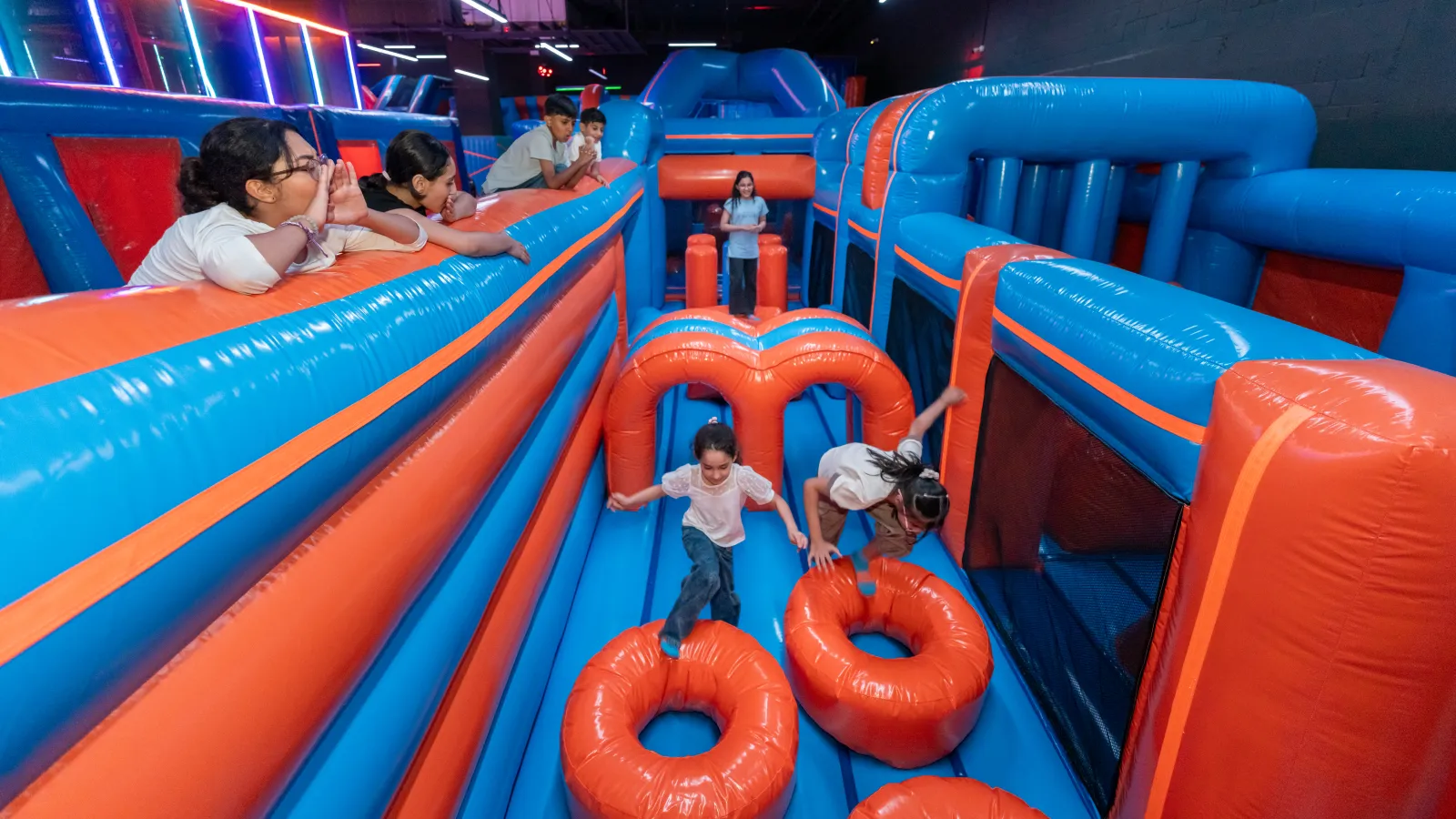 Kids enjoying the inflatables area